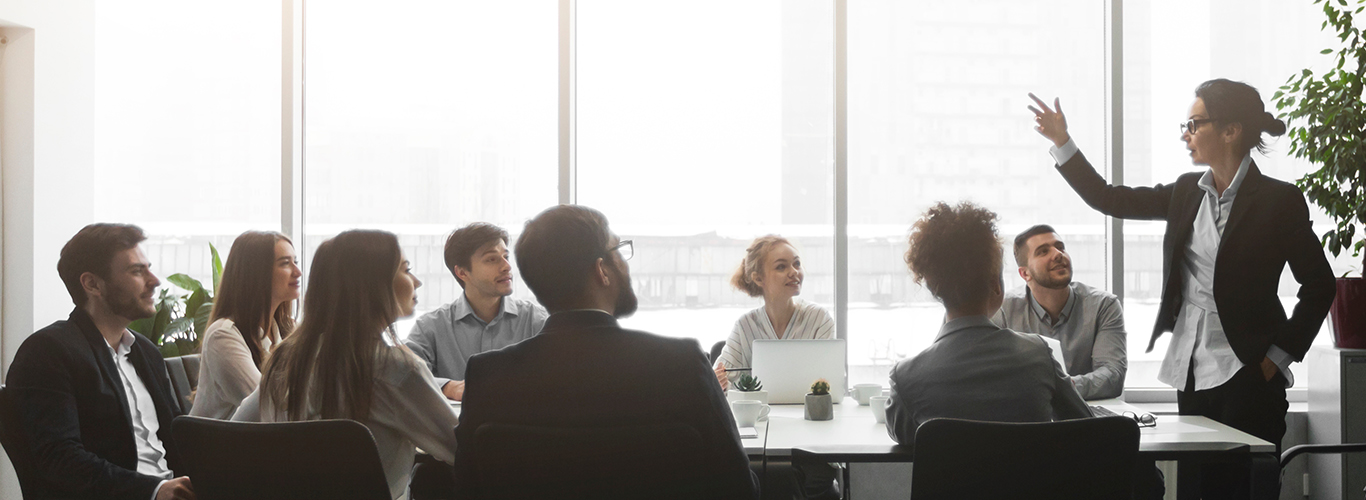 Boss talking to employees, having brainstorm meeting in office Boss talking to employees, having brainstorm meeting in office, side view, panorama